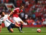 Morgan Schneiderlin of Manchester United and Mousa Dembele of Tottenham Hotspur compete for the ball during the Barclays Premier League match between Manchester United and Tottenham Hotspur at Old Trafford on August 8, 2015 in Manchester, England. 