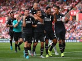 Liverpool players celebrate with Philippe Coutinho after the Brazilian's winning goal against Stoke City in the Premier League on August 9, 2015