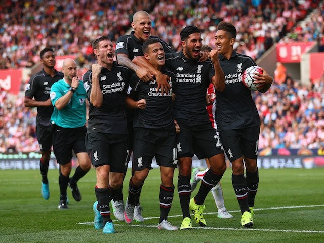 Liverpool players celebrate with Philippe Coutinho after the Brazilian's winning goal against Stoke City in the Premier League on August 9, 2015