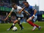 Ben Davies of Portsmouth is tackled by Andreas Weimann of Derby County during the Capital One Cup First Round match between Portsmouth v Derby County at Fratton Park on August 12, 2015