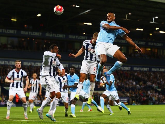 Vincent Kompany of Manchester City scores their third goal during the Barclays Premier League match between West Bromwich Albion and Manchester City at The Hawthorns on August 10, 2015
