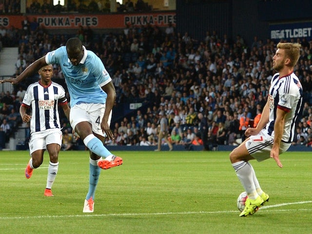 Manchester City's Ivorian midfielder Yaya Toure (L) scores from a deflection during the English Premier League football match between West Bromwich Albion and Manchester City at The Hawthorns in West Bromwich, central England, on August 10, 2015