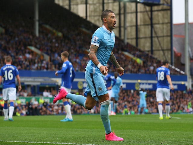 Aleksandar Kolarov of Manchester City celebrates scoring the opening goal during the Barclays Premier League match between Everton and Manchester City at Goodison Park on August 23, 2015