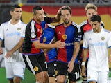 Basel's Czech defender Marek Suchy congratulates his teammate Argentinian midfielder Matias Delgado after he score a penalty during the UEFA Champions League playoff football match between FC Basel and Maccabi Tel Aviv at the St Jakob Park stadium in Base