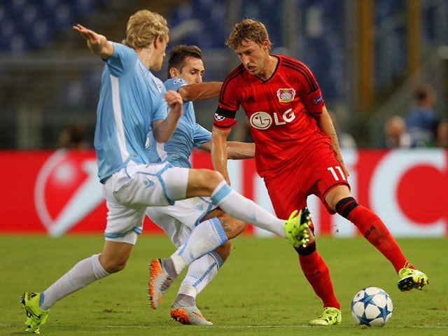 Stefan Kiessling (R) of Bayer Leverkusen competes for the ball with Miroslav Klose (C) and Dusan Basta of SS Lazio during the UEFA Champions League qualifying round play off first leg match between SS Lazio and Bayer Leverkusen at Olimpico Stadium on Augu