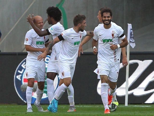 Augsburg's players celebrate Brazilian midfielder Caiuby scoring the 1-0 during the German first division Bundesliga football match Eintracht Frankfurt v FC Augsburg, on August 22, 2015