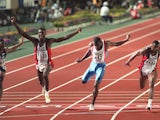 US sprinter Carl Lewis (2nd L) celebrates after winning the 100m final in a world record time of 9.86 sec at the World Athletics Championships, 25 August 1991