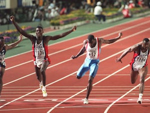 US sprinter Carl Lewis (2nd L) celebrates after winning the 100m final in a world record time of 9.86 sec at the World Athletics Championships, 25 August 1991