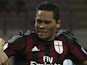 Carlos Bacca (R) of AC Milan is challenged by Massimo Volta (L) of AC Perugia during the TIM Cup match between AC Milan and AC Perugia at Stadio Giuseppe Meazza on August 17, 2015