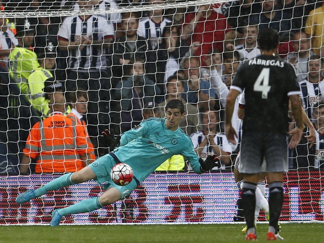 Chelsea's Belgian goalkeeper Thibaut Courtois dives to save a penalty taken by West Bromwich Albion's English-born Scottish midfielder James Morrison (not pictured) during the English Premier League football match between West Bromwich Albion and Chelsea 