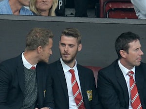 Manchester United's Spanish goalkeeper David de Gea (centre right) sits in the stands ahead of the English Premier League football match between Manchester United and Newcastle United at Old Trafford in Manchester, north west England, on August 22, 2015
