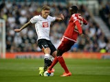 Jeff Hendrick of Derby County challenges Albert Adomah of Middlesbrough during the Sky Bet Championship match between Derby County and Middlesbrough at Pride Park Stadium on August 18, 2015