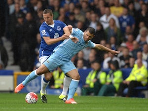 Everton's English defender Phil Jagielka vies with Manchester City's Argentinian striker Sergio Aguero during the English Premier League football match between Everton and Manchester City at Goodison Park in Liverpool on August 23, 2015
