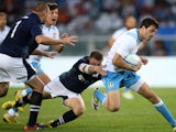 Italy's Giovanbattista Venditti tries to avoid a tackle during the Rugby World Cup Test match Italy Vs Scotland on August 22, 2015 
