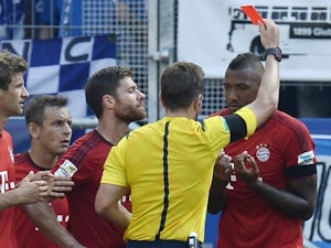 Referee Tobias Stieler shows the red card to Bayern Munich's defender Jerome Boateng during the German first division Bundesliga football match 1899 Hoffenheim v FC Bayern Munich, on August 22, 2015