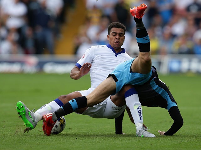 Liam Palmer of Sheffield Wednesday FC falls over Stuart Dallas of Leeds United FC in a tackle during the Sky Bet Championship match between Leeds United and Sheffield Wednesday at Elland Road on August 22, 2015 