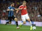 Club Brugge's Belgian forward Tuur Dierckx (L) challenges Manchester United's English defender Luke Shaw during the UEFA Champions League play off football match between Manchester United and Club Brugge at Old Trafford in Manchester, north west England, 