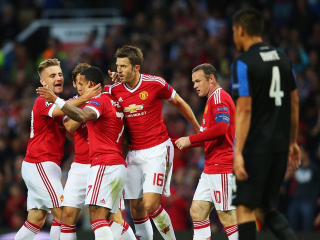 Memphis Depay of Manchester United celebrates scoring his team's opening goal with team mates during the UEFA Champions League Qualifying Round Play Off First Leg match between Manchester United and Club Brugge at Old Trafford on August 18, 2015