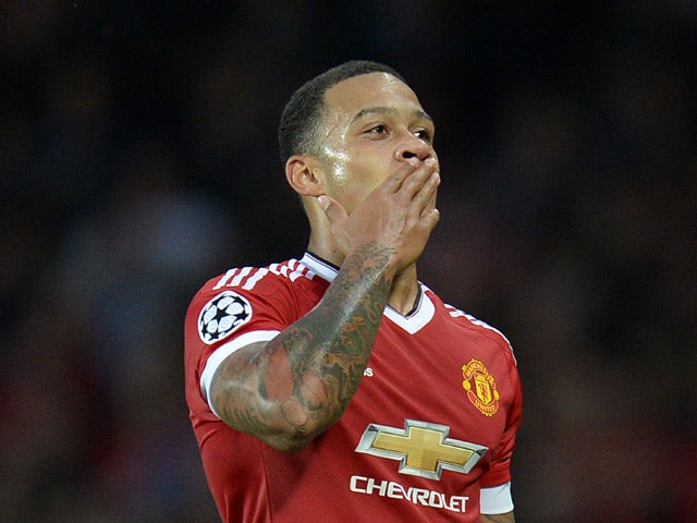 Manchester United's Dutch midfielder Memphis Depay celebrates after scoring his team's second goal during the UEFA Champions League play off football match between Manchester United and Club Brugge at Old Trafford in Manchester, north west England, on Aug