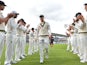 Australia's captain Michael Clarke receives a guard of honour from his Australia teammates as he leaves the field after Australia wrap up the game on the fourth day of the fifth Ashes cricket test match between England and Australia at The Oval cricket gr