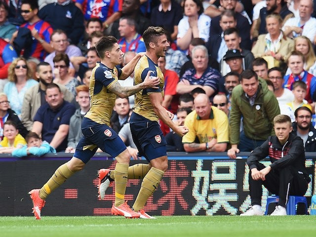 Olivier Giroud celebrates scoring Arsenal's first goal with Hector Bellerin on August 16, 2015