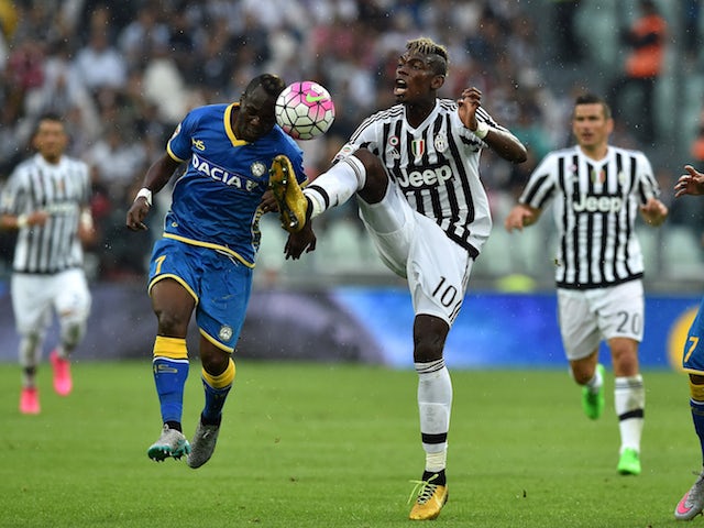 Paul Pogba (R) of Juventus FC is challenged by Emmanuel Badu of Udinese Calcio during the Serie A match between Juventus FC and Udinese Calcio at Juventus Arena on August 23, 2015