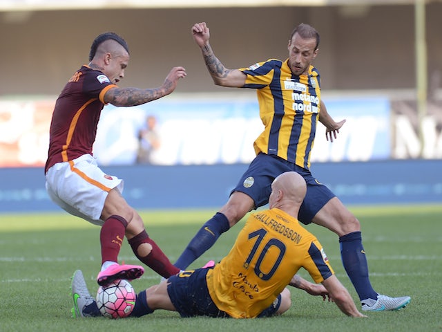 Radja Nainggolan (L) of AS Roma battles for the ball with Emil Hallfredsson #10 and Evangelos Moras of Hellas Verona during the Serie A match between Hellas Verona FC and AS Roma at Stadio Marc'Antonio Bentegodi on August 22, 2015