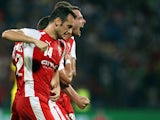 Skenderbeu's Bledi Shkembi (R) and teammates celebrate after the opening goal during the UEFA Champions League playoff football match between KF Skenderbeu and Dinamo Zagreb at the Elbansan Arena in Elbasan, Albania on August 19, 2015