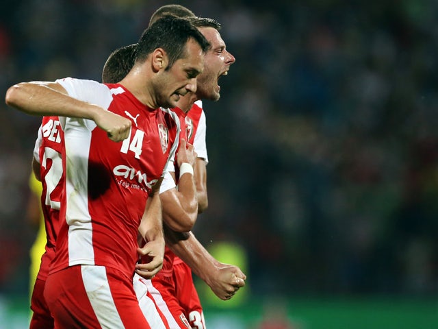 Skenderbeu's Bledi Shkembi (R) and teammates celebrate after the opening goal during the UEFA Champions League playoff football match between KF Skenderbeu and Dinamo Zagreb at the Elbansan Arena in Elbasan, Albania on August 19, 2015