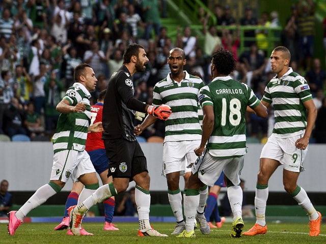 Sporting's goolkeeper Rui Patricio celebrates with teammates after stopping a penalty kick during the UEFA Champions League play off football match Sporting Portugal vs CSKA Moscou at the Jose Alvalade stadium in Lisbon on August 18, 2015