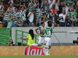 Sporting's forward Teofilo Gutierrez celebrates scoring a goal with Sporting's forward Andre Carrillo during the UEFA Champions League qualifying round play-off first leg match between Sporting CP and CSKA Moscow at Estadio Jose Alvalade on August 18, 201