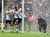 Dele Alli of Tottenham Hotspur celebrates scoring his team's first goal with his team mates Tom Carroll and Harry Kane during the Barclays Premier League match between Leicester City and Tottenham Hotspur at The King Power Stadium on August 22, 2015