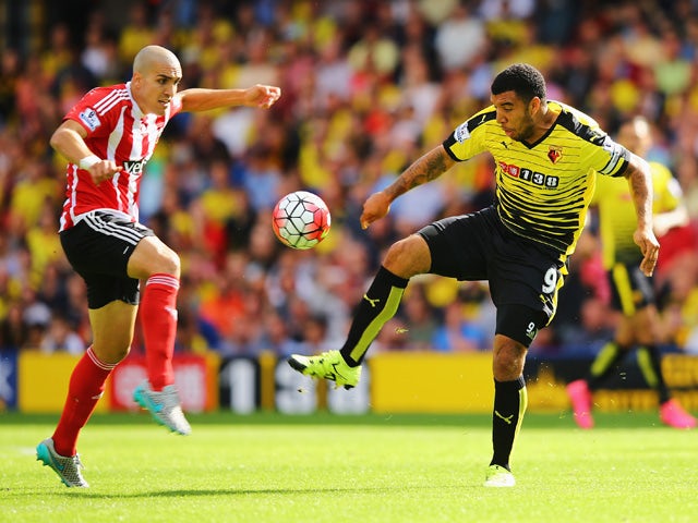 Troy Deeney of Watford is challenged by Oriol Romeu of Southampton during the Barclays Premier League match between Watford and Southampton at Vicarage Road on August 23, 2015