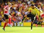 Troy Deeney of Watford is challenged by Oriol Romeu of Southampton during the Barclays Premier League match between Watford and Southampton at Vicarage Road on August 23, 2015