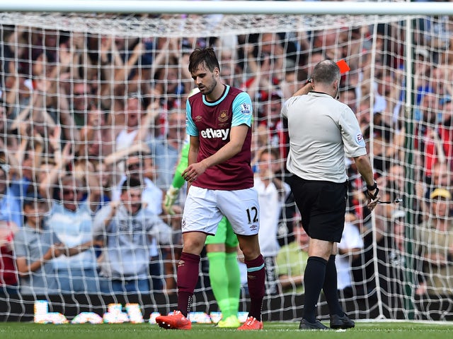 West Ham United's English midfielder Carl Jenkinson walks from the pitch after receiving a red card from referee Jon Moss during the English Premier League football match between West Ham United and Bournemouth at The Boleyn Ground in Upton Park, East Lon