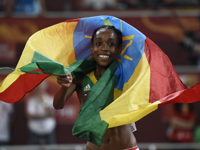 Ethiopia's Almaz Ayana celebrates winning the final of the women's 5000 metres athletics event at the 2015 IAAF World Championships at the 'Bird's Nest' National Stadium in Beijing on August 30, 2015