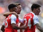 Alex Oxlade-Chamberlain, Nacho Monreal and Hector Bellerin of Arsenal celebrates their team's first goal scored by Fabricio Coloccini (not pictured) of Newcastle United during the Barclays Premier League match between Newcastle United and Arsenal at St Ja