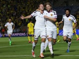 Basel's players celebrate after scoring their first goal during the UEFA Champions League playoff football match second leg between FC Basel and Maccabi Tel Aviv at the Bloomfield Stadium in Tel Aviv on August 25, 2015