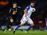 Grant Hanley of Blackburn Rovers holds off a challenge from Zach Clough of Bolton Wanderers during the Sky Bet Championship match between Blackburn Rovers and Bolton Wanderers at Ewood park on August 28, 2015