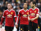 Daley Blind (R) of Manchester United looks dejected with Wayne Rooney (L) and Memphis Depay after Barclays Premier League match between Swansea City and Manchester United at Liberty Stadium on August 30, 2015 