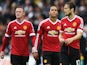 Daley Blind (R) of Manchester United looks dejected with Wayne Rooney (L) and Memphis Depay after Barclays Premier League match between Swansea City and Manchester United at Liberty Stadium on August 30, 2015 