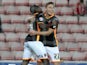 Exeter City's English midfielder David Wheeler celebrates with Exeter City's English midfielder Manny Oyeleke (L) after scoring their second goal during the English League Cup second round football match between between Sunderland and Exeter City at the S