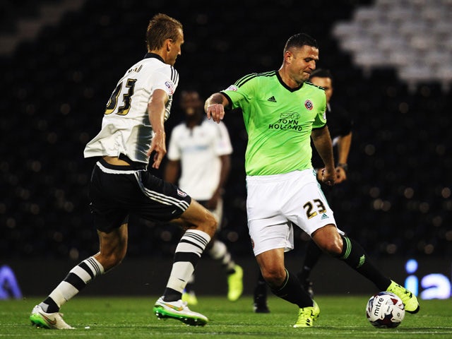Dan Burn of Fulham and Michael Higdon of Sheffield United challenge for the ball during the Capital One League Cup Second Round match between Fulham and Sheffield United at Craven Cottage on August 25, 2015