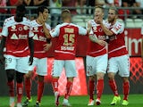 Reims' Gaëtan Charbonnier (2ndR) is congratulated by teammates after scoring a goal during the French L1 football match between Reims and Lorient on August 31, 2015