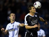 Dean Hammond of Leicester City wins a header with Danny Pugh of Bury during the Capital One Cup second round match between Bury and Leicester City at Gigg Lane on August 25, 2015