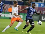 Troyes' French midfielder Lossemy Karaboue (R) vies with Montpellier's French midfielder Paul Lasne (L) during the French L1 football match between Troyes and Montpellier on August 29, 2015