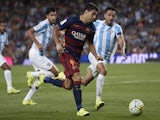 Barcelona's Uruguayan forward Luis Suarez (C) vies with Malaga's Brazilian defender Weligton during the Spanish league football match FC Barcelona vs Malaga CF at the Camp Nou stadium in Barcelona on August 29, 2015