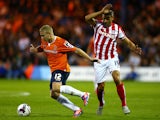 Scott Griffiths of Luton Town is closed down by Jonathan Walters of Stoke City during the Capital One Cup second round match between Luton Town and Stoke City at Kenilworth Road on August 25, 2015