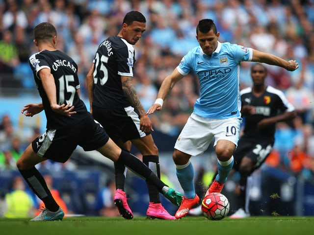 Sergio Aguero (R) of Manchester City competes against Craig Cathcart (L) and Jose Holebas (C) of Watford during the Barclays Premier League match between Manchester City and Watford at Etihad Stadium on August 29, 2015