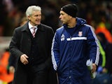 Stoke City manager Mark Hughes and his assistant Mark Bowen talk at the end of the Budweiser FA Cup third round match between Stoke City and Leicester City at the Britannia Stadium on January 4, 2014